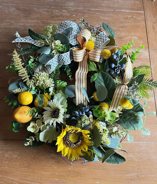 Wreath of silk sunflowers and striped ribbon