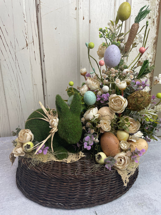 a spring and easter themed floral centerpiece with made with a vintage bakset and vintage doily accents