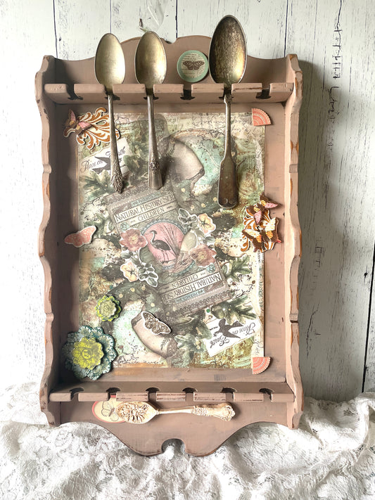 Upccled vintage spoon holder for wall with art assemblage of vintage silver spoons, collage, and clay in a floral theme