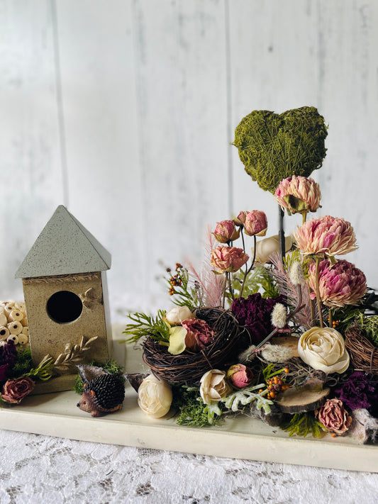 dried florals table vignette with dried peonies and dried roses and featuring a bird house