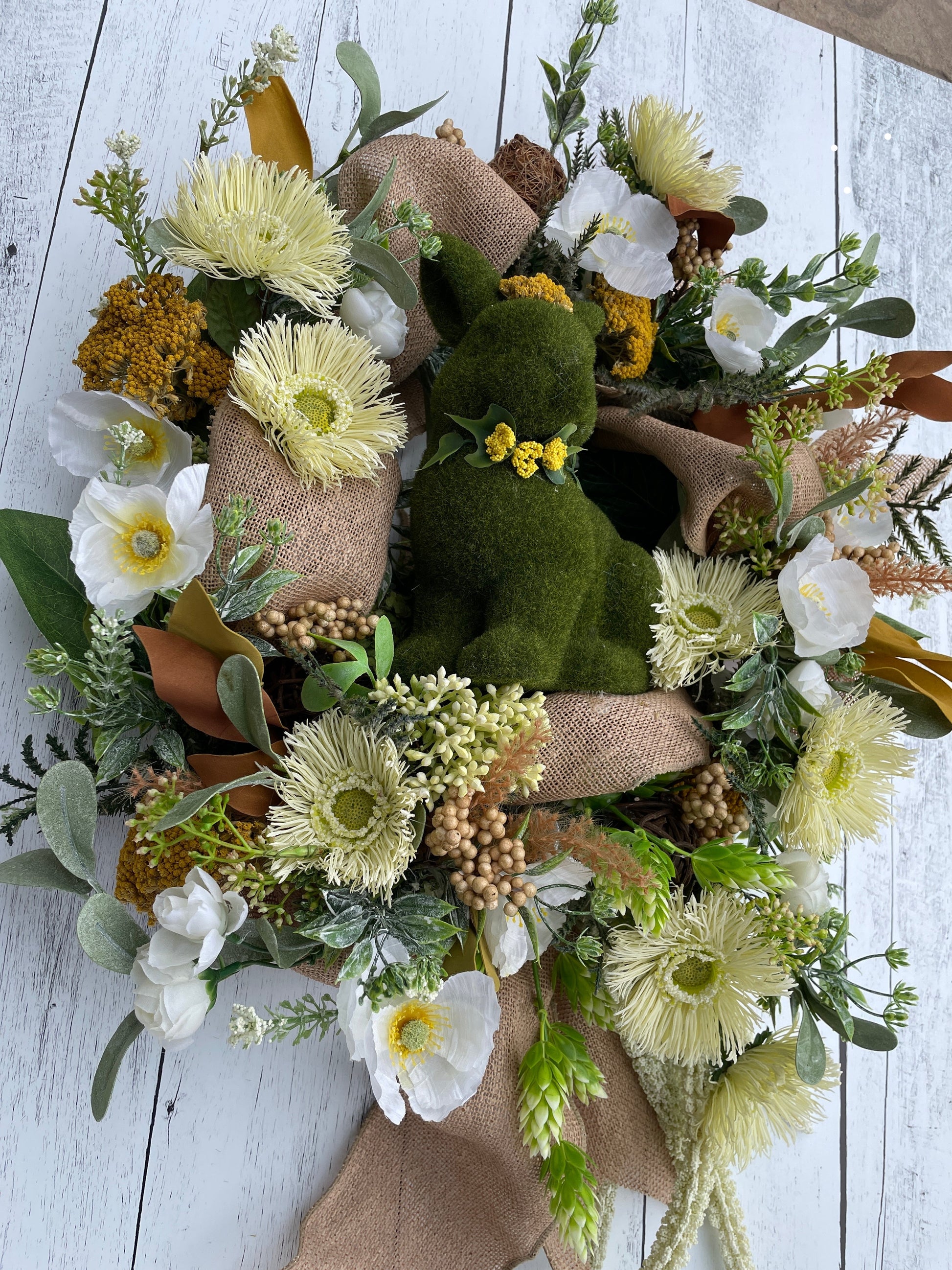 large floral wreath for indoor decor, with large moss covered bunny and white poppies with burlap ribbon
