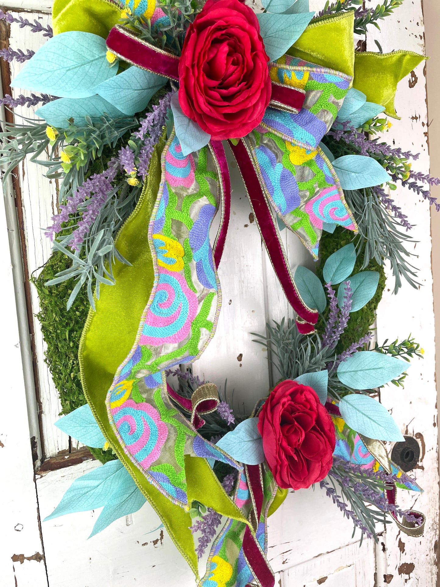 Colorful floral wreath with tapestry ribbon
