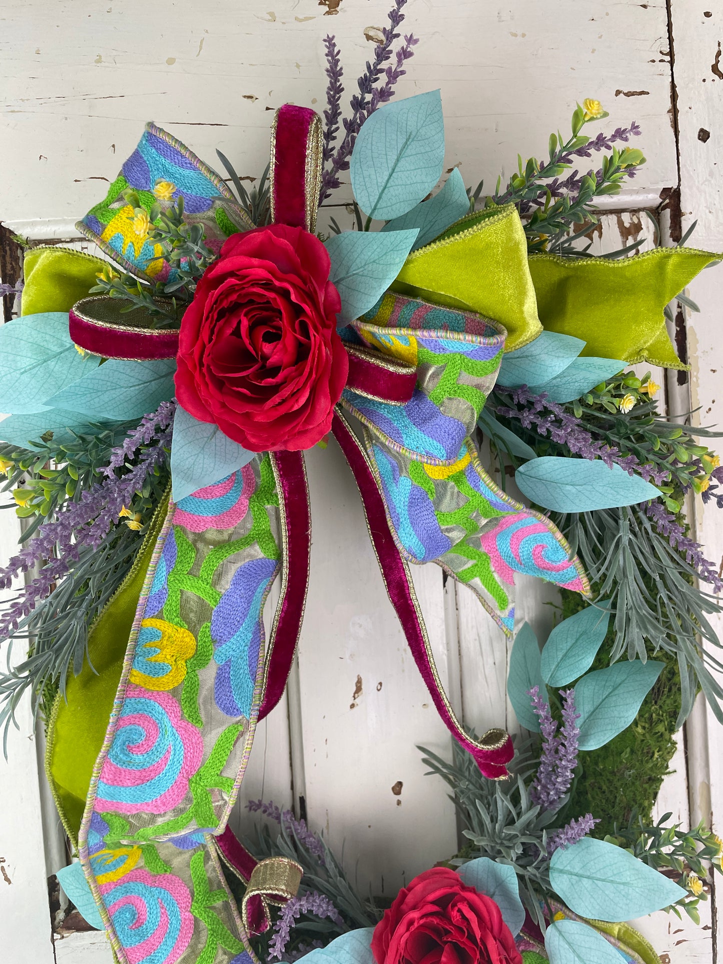 Colorful floral wreath with tapestry ribbon