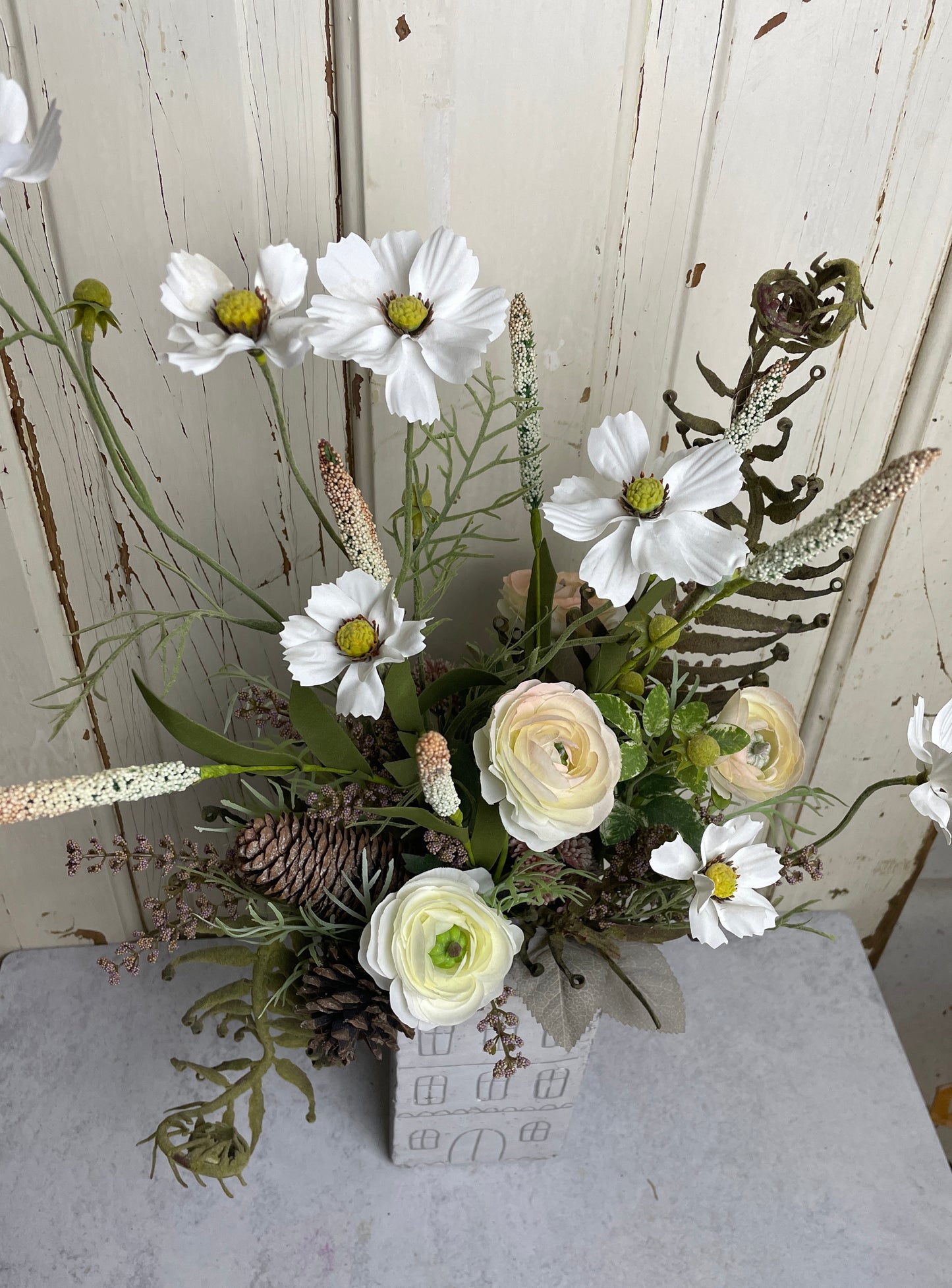 Neutral floral arangement in ceramic house planter