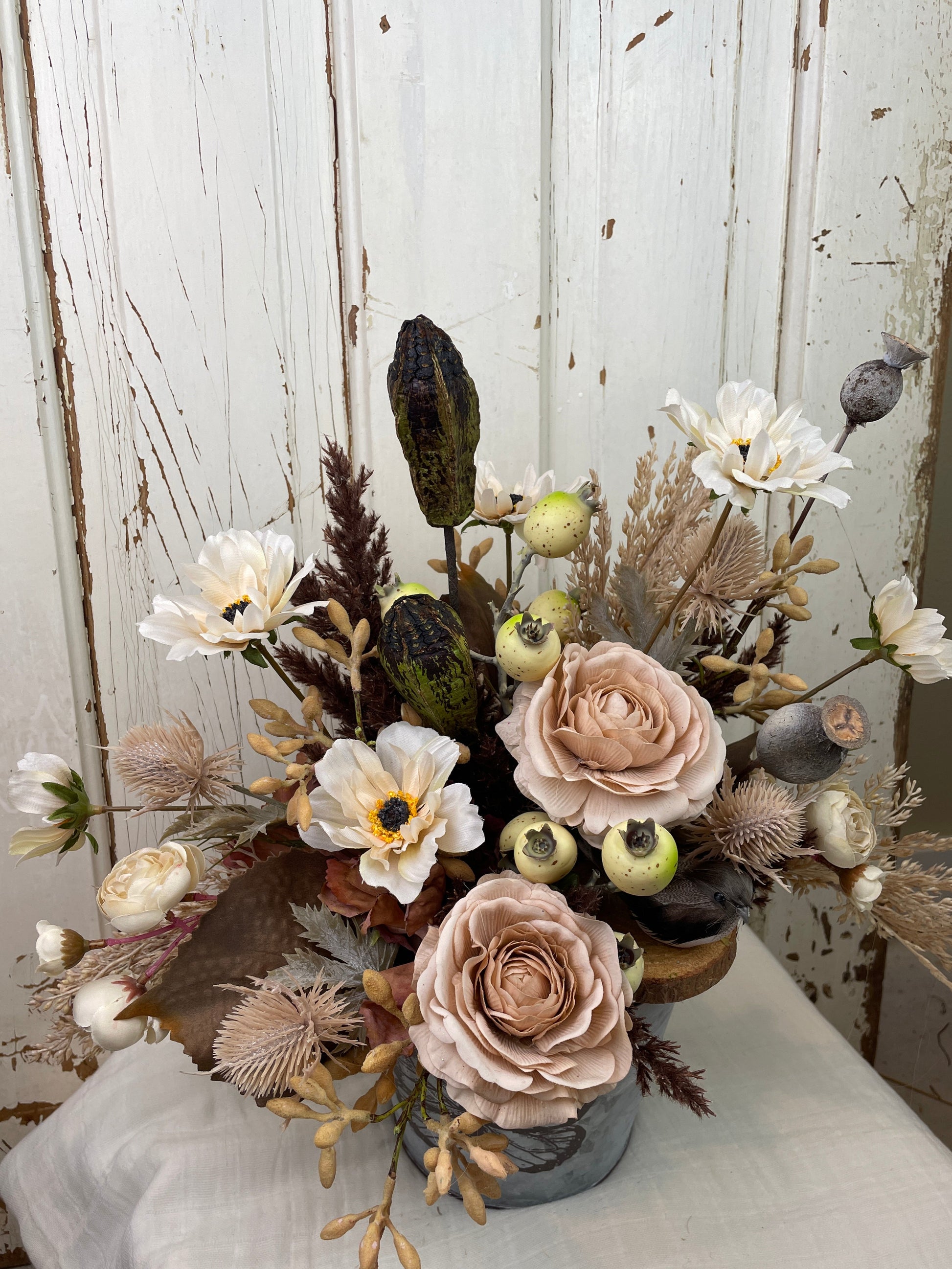 Boho style Wedding table centerpiece with blush roses, natural floral pods, and faux pampas grasses