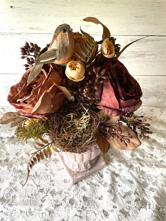 fall floral arrangement with dark red roses in a clay urn por
