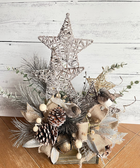 rustic floral arrangement with large faux stars and pine cones in neutral colors