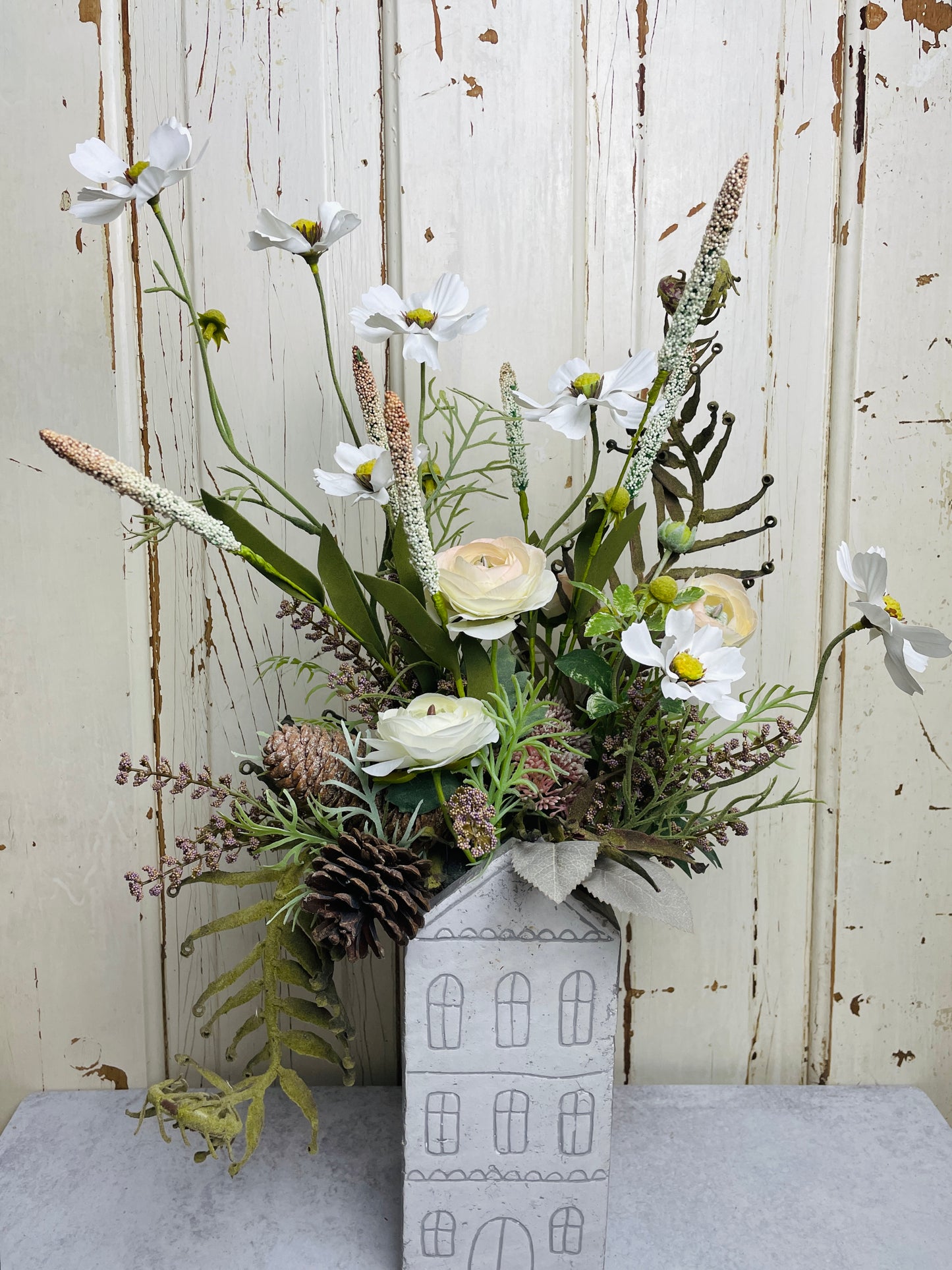 Neutral floral arangement in ceramic house planter