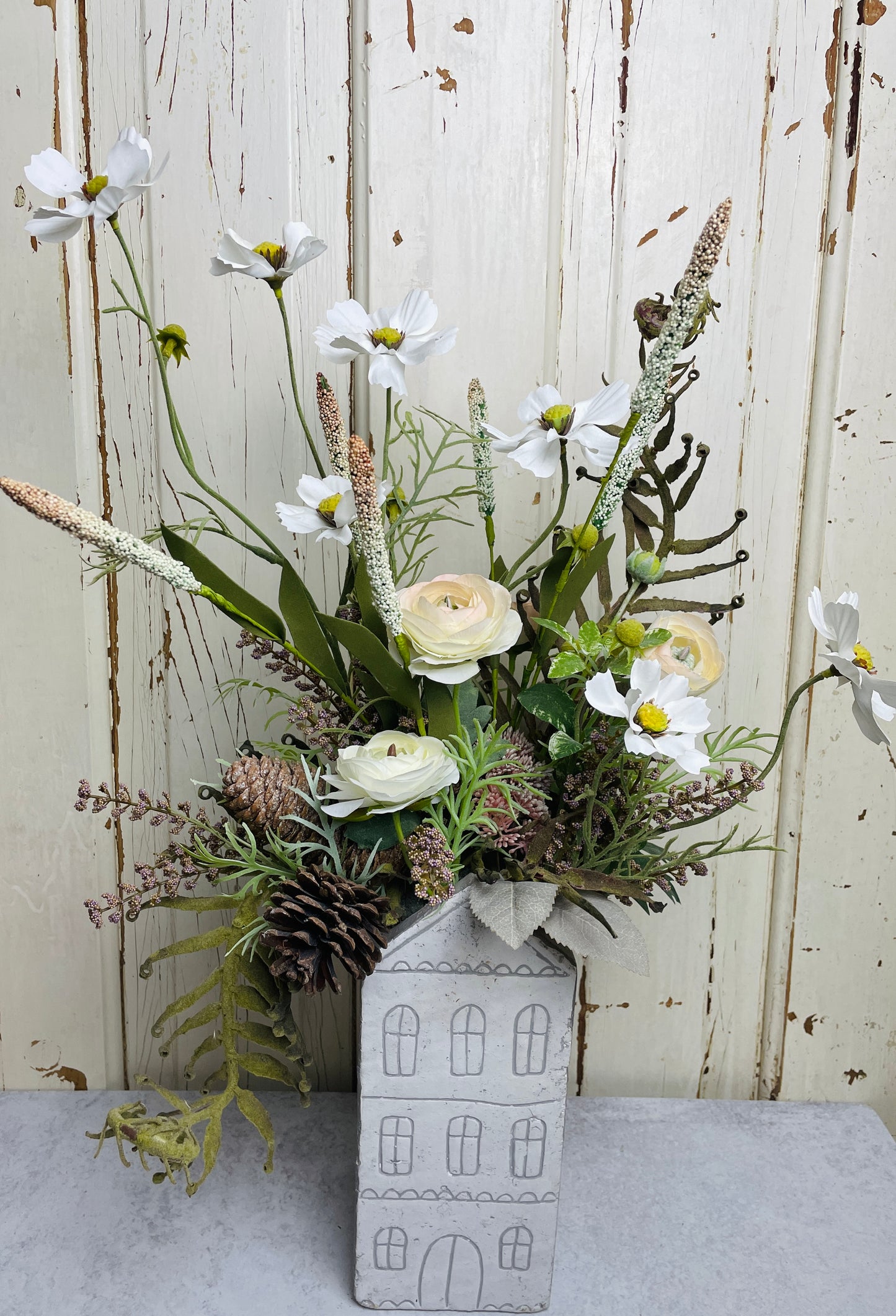 Neutral floral arangement in ceramic house planter