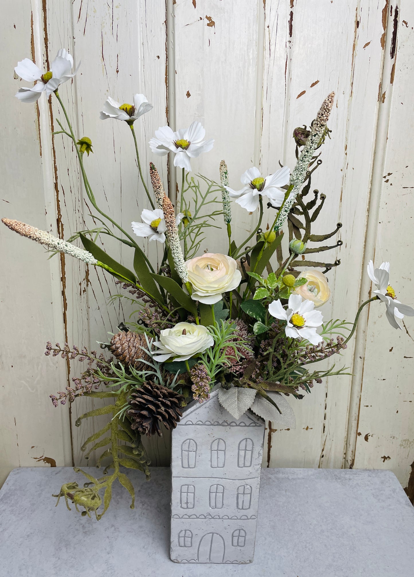 Neutral floral arangement in ceramic house planter