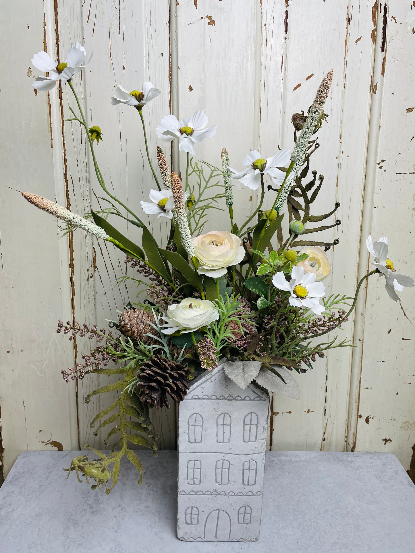 Neutral floral arangement in ceramic house planter