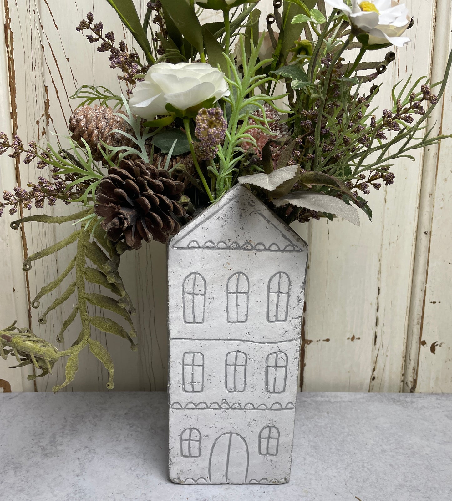 Neutral floral arangement in ceramic house planter