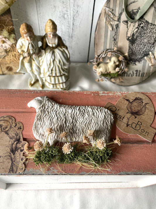A wooden crate with coral chalk paint has a french inspired farm sheep and french quotes 