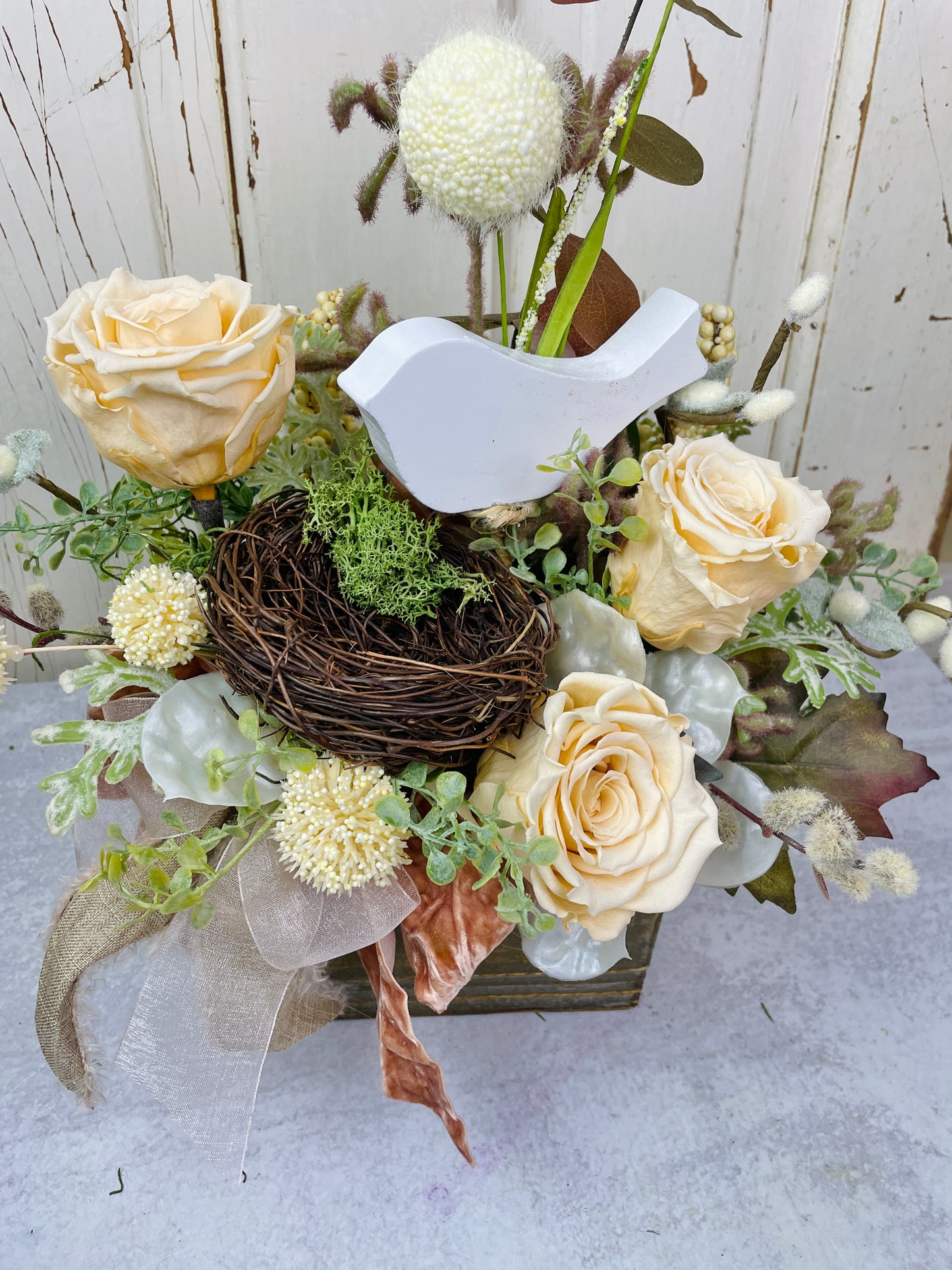 Dried floral arrangement with roses and birds nest