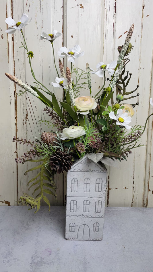 Neutral floral arangement in ceramic house planter